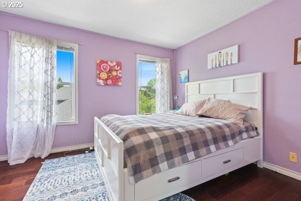15395 SW Emerald St, Beaverton, OR 97007 - bedroom featuring multiple windows, baseboards, and dark wood-style flooring