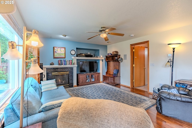 428 SE 11th Cir, Troutdale, OR 97060 - living area with wood finished floors, ceiling fan, and a fireplace