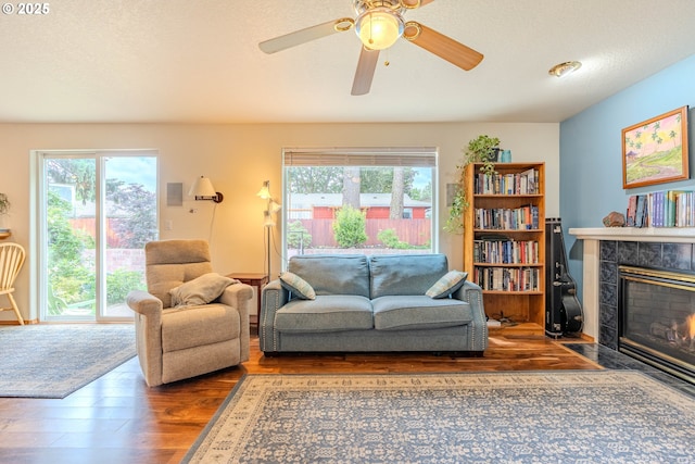 428 SE 11th Cir, Troutdale, OR 97060 - living room featuring wood finished floors, a tile fireplace, and a ceiling fan
