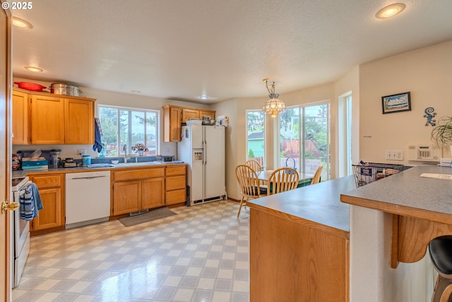 428 SE 11th Cir, Troutdale, OR 97060 - kitchen featuring white appliances, a peninsula, healthy amount of natural light, light floors, and recessed lighting