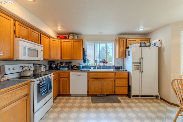 428 SE 11th Cir, Troutdale, OR 97060 - kitchen featuring white appliances, dark countertops, light flooring, recessed lighting, and brown cabinetry