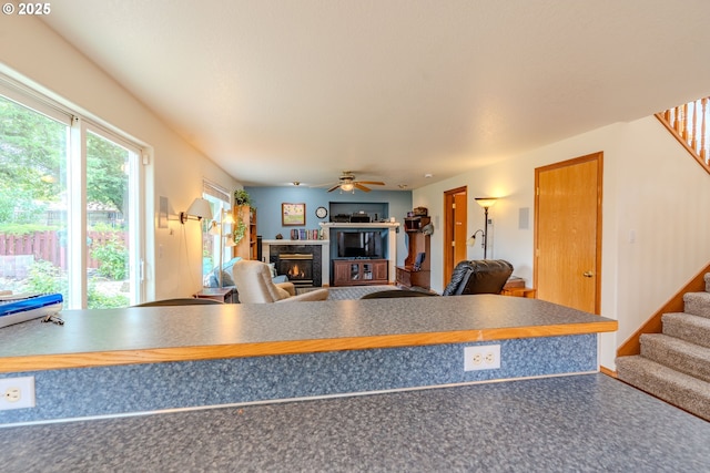 428 SE 11th Cir, Troutdale, OR 97060 - kitchen with a glass covered fireplace, a ceiling fan, open floor plan, and dark countertops