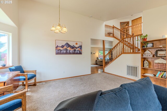 428 SE 11th Cir, Troutdale, OR 97060 - carpeted living room with a chandelier, a towering ceiling, and stairs