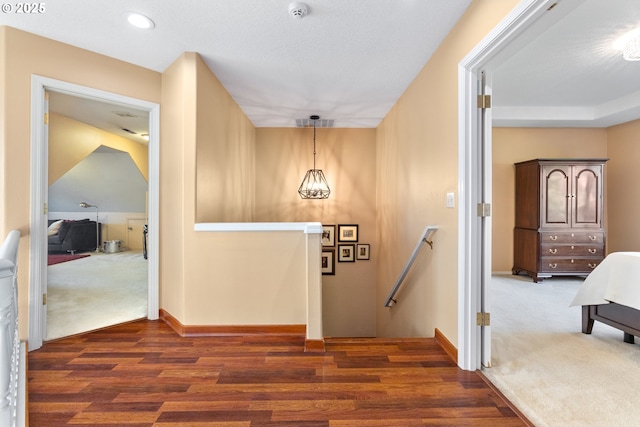 hall with carpet, baseboards, an upstairs landing, recessed lighting, and wood finished floors