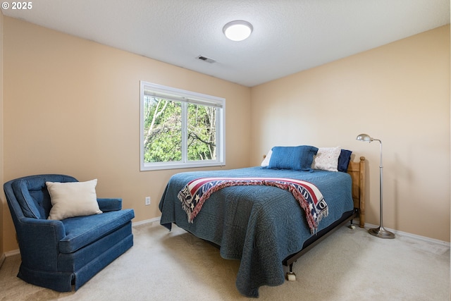 carpeted bedroom featuring visible vents, a textured ceiling, and baseboards