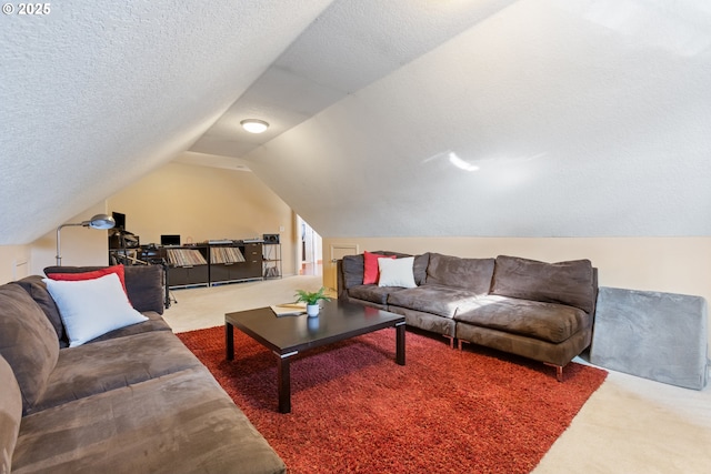 carpeted living area with a textured ceiling and vaulted ceiling