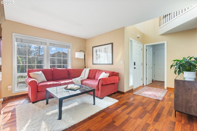 living area with baseboards and wood finished floors