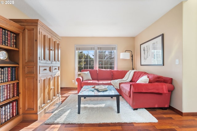 living area with wood finished floors and baseboards