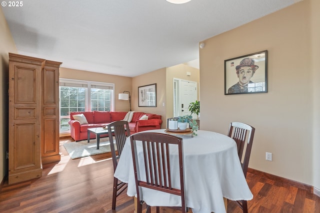 dining area with dark wood-style floors and baseboards