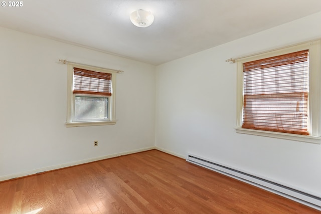 spare room with light hardwood / wood-style flooring and a baseboard radiator