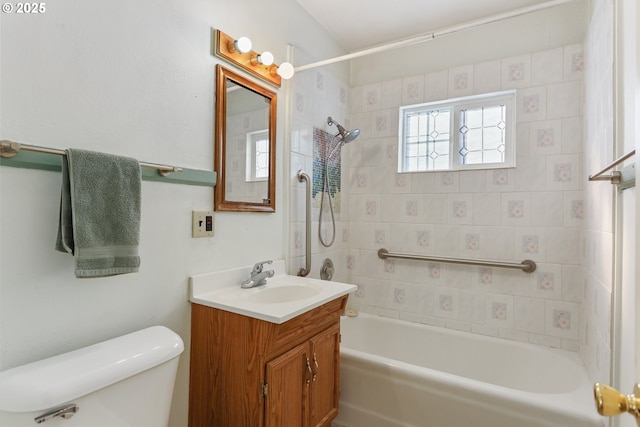 full bathroom with vanity, tiled shower / bath, and toilet