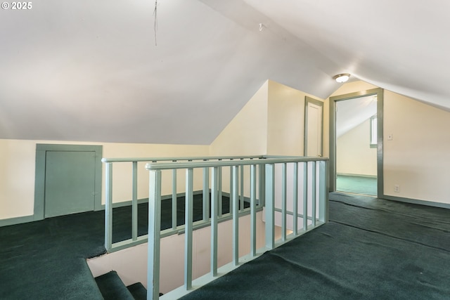 bonus room featuring dark colored carpet and vaulted ceiling