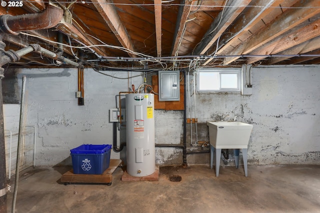 basement featuring water heater, sink, and electric panel