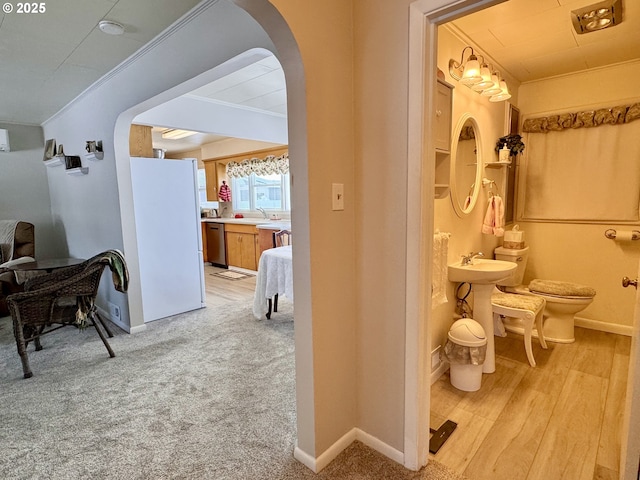 bathroom with sink, crown molding, toilet, and hardwood / wood-style flooring