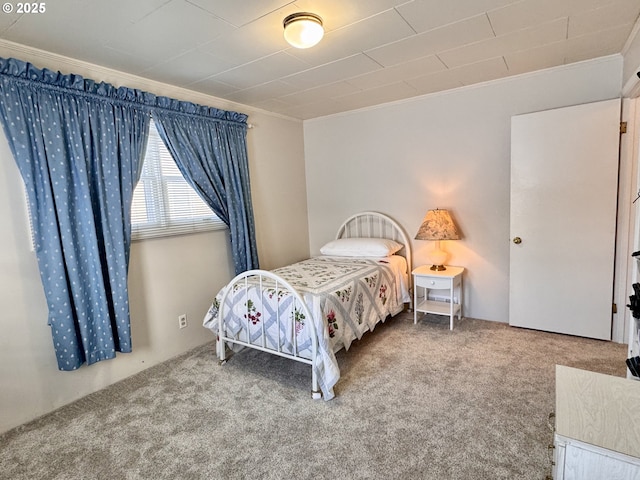 bedroom with crown molding and carpet