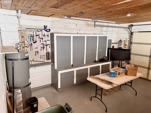 garage featuring wooden ceiling and a workshop area