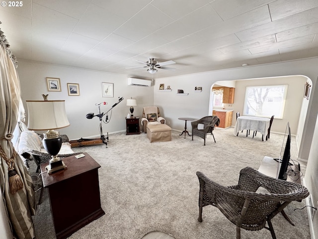 carpeted living room featuring a wall mounted air conditioner and ceiling fan