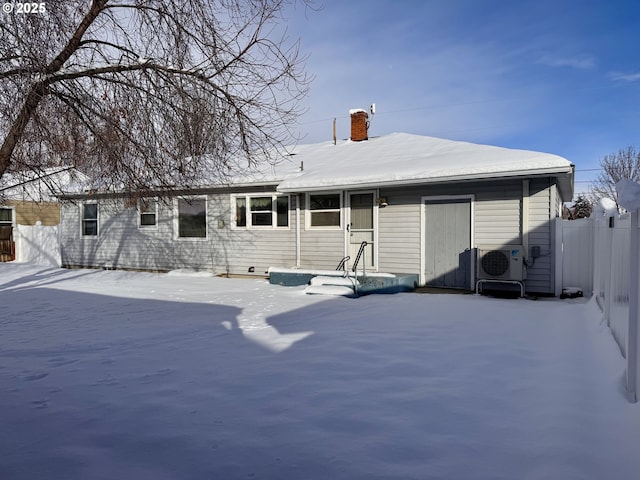 snow covered property with ac unit