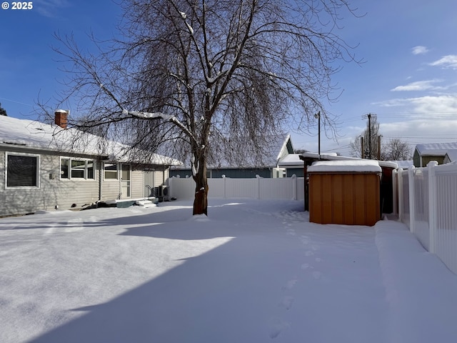 yard covered in snow with a jacuzzi