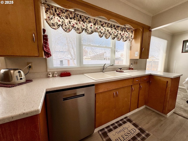 kitchen featuring ornamental molding, dishwasher, and sink