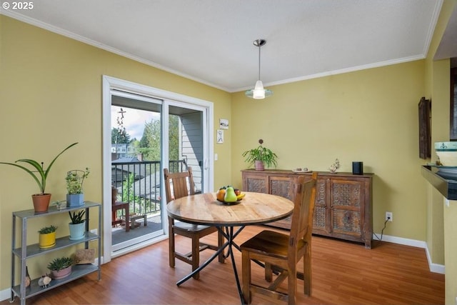 6600 SE Division St Unit 304, Portland, OR 97206 - dining area with crown molding, baseboards, and wood finished floors