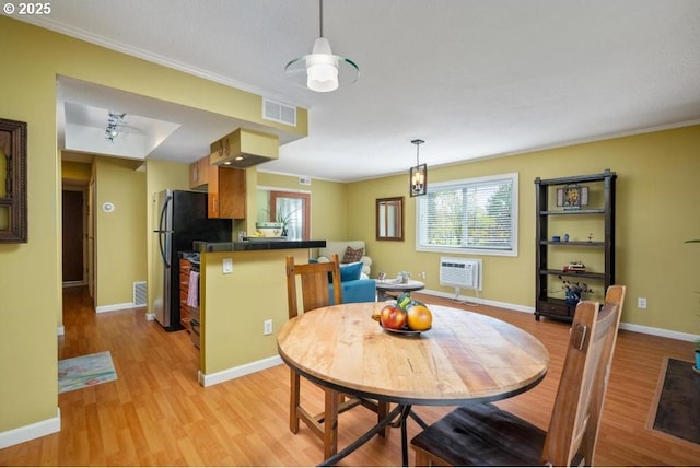 6600 SE Division St Unit 304, Portland, OR 97206 - dining area with baseboards, visible vents, light wood finished floors, and a wealth of natural light