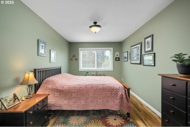 6600 SE Division St Unit 304, Portland, OR 97206 - bedroom featuring dark wood-type flooring and baseboards