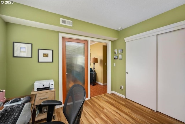6600 SE Division St Unit 304, Portland, OR 97206 - home office featuring baseboards, visible vents, and light wood-type flooring