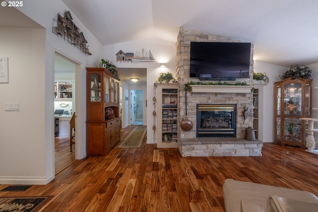 5 Woodthrush Ln, Gleneden Beach, OR 97388 - living room with vaulted ceiling, wood finished floors, a stone fireplace, and baseboards