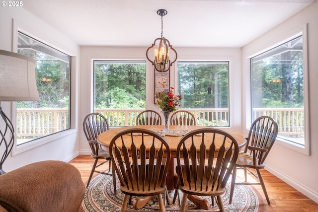 5 Woodthrush Ln, Gleneden Beach, OR 97388 - dining space featuring a chandelier, baseboards, and light wood-type flooring