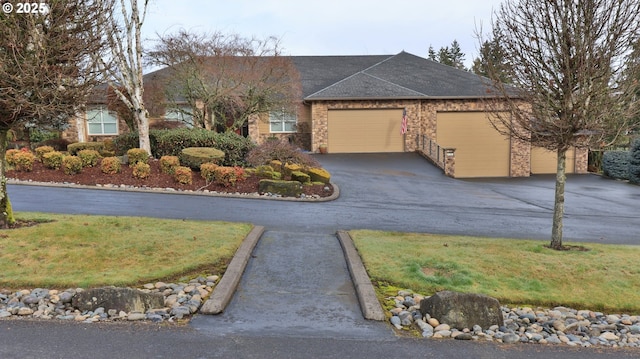 single story home with driveway and an attached garage