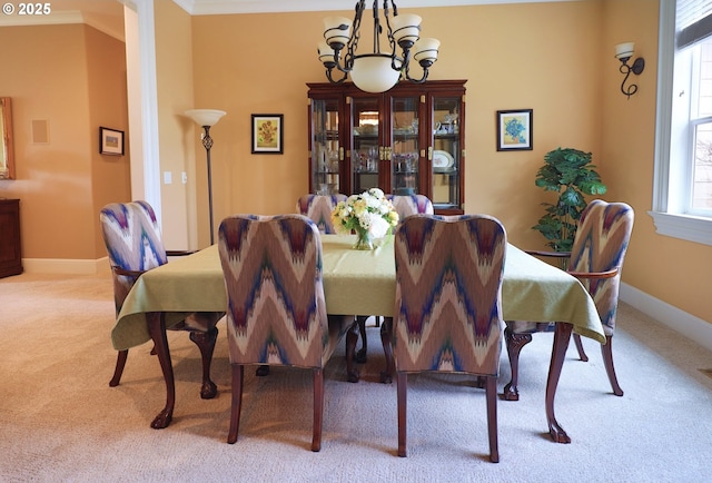 carpeted dining room featuring baseboards and a notable chandelier