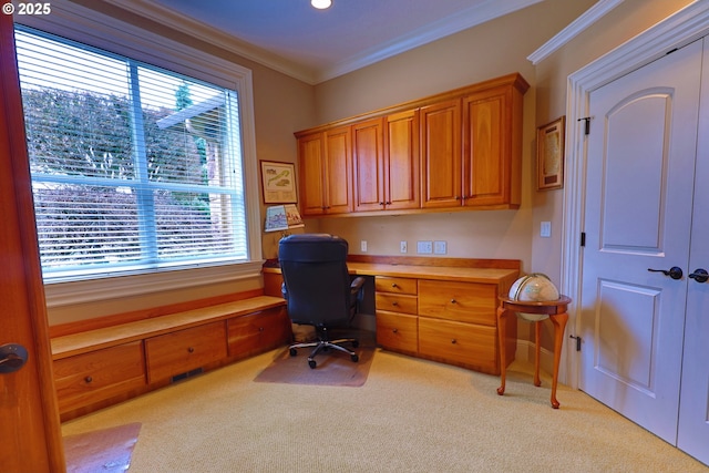 office featuring ornamental molding, light colored carpet, and built in desk