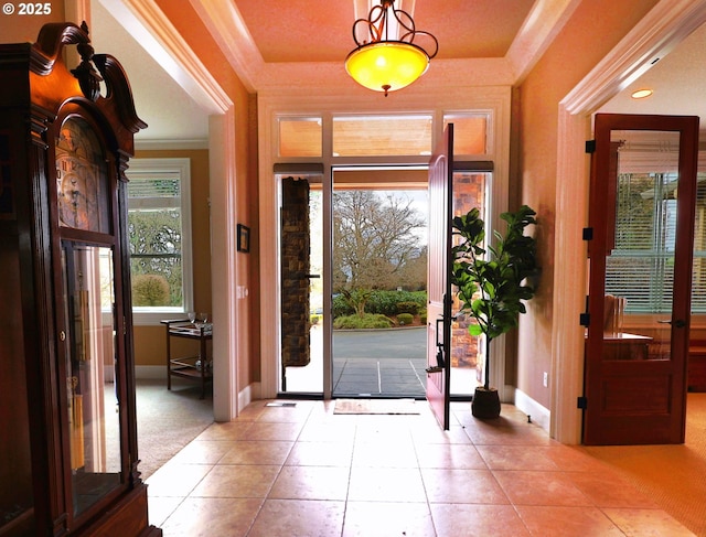 foyer with french doors, crown molding, baseboards, and tile patterned floors