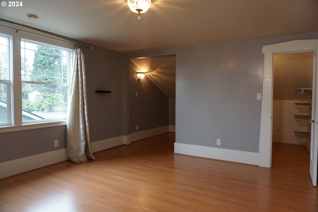 empty room with light hardwood / wood-style flooring