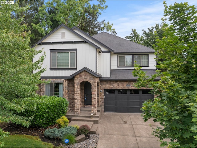 12647 SW 21st Ct, Lake Oswego, OR 97035 - view of front of property featuring concrete driveway, an attached garage, stone siding, board and batten siding, and a shingled roof