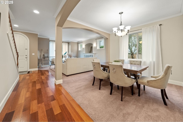 12647 SW 21st Ct, Lake Oswego, OR 97035 - dining area featuring arched walkways, crown molding, a chandelier, light wood-style flooring, and recessed lighting