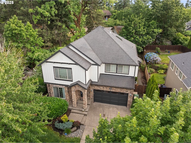 12647 SW 21st Ct, Lake Oswego, OR 97035 - view of front of home with stone siding, roof with shingles, a garage, and concrete driveway