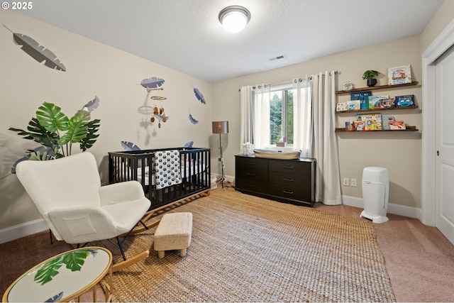 12647 SW 21st Ct, Lake Oswego, OR 97035 - bedroom featuring a crib, light colored carpet, and a textured ceiling