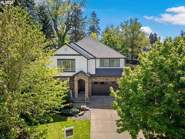 view of front facade with an attached garage, roof with shingles, stone siding, and concrete driveway
