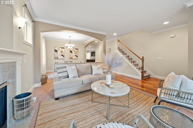 12647 SW 21st Ct, Lake Oswego, OR 97035 - living room featuring arched walkways, stairway, recessed lighting, a fireplace, and crown molding