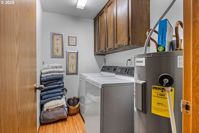 laundry area with water heater, cabinet space, and separate washer and dryer