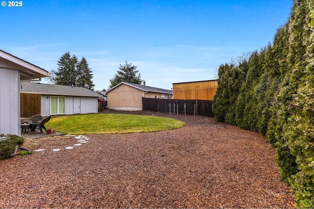 view of yard with fence and a patio