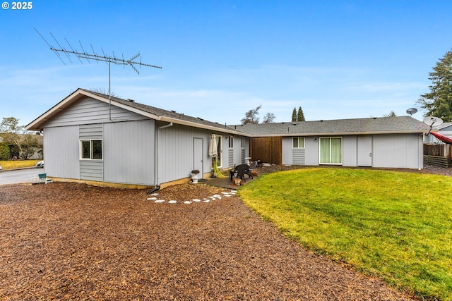 ranch-style house featuring a front yard and fence