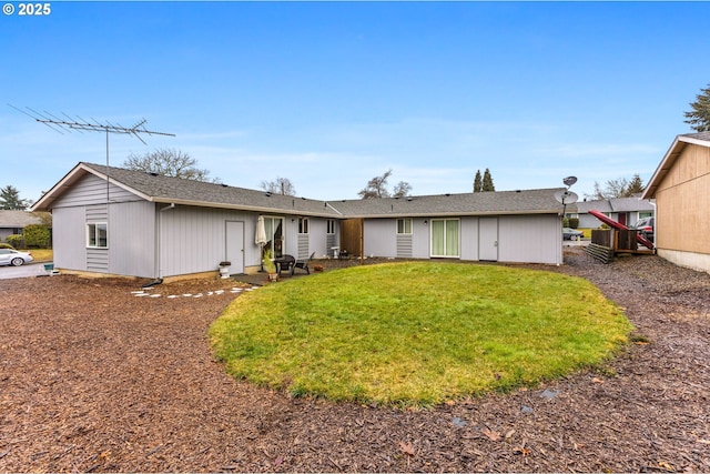 rear view of property with a yard