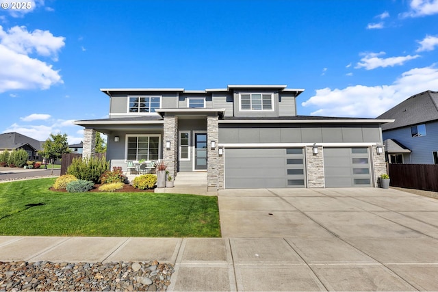 2625 NE 8th Ave, Battle Ground, WA 98604 - prairie-style home featuring stone siding, concrete driveway, covered porch, and a garage