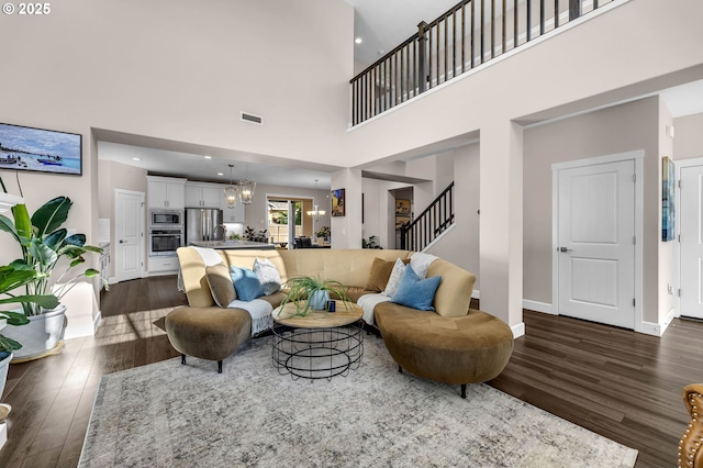 2625 NE 8th Ave, Battle Ground, WA 98604 - living area with dark wood finished floors, a high ceiling, stairs, and baseboards