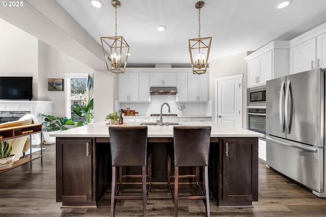 2625 NE 8th Ave, Battle Ground, WA 98604 - kitchen with appliances with stainless steel finishes, a chandelier, backsplash, light countertops, and recessed lighting
