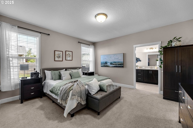 2625 NE 8th Ave, Battle Ground, WA 98604 - bedroom with light carpet, baseboards, a textured ceiling, and ensuite bath