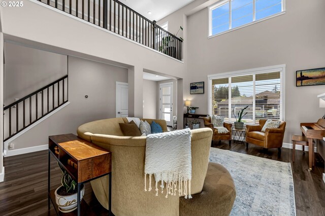 2625 NE 8th Ave, Battle Ground, WA 98604 - living room with dark wood-style flooring, stairway, healthy amount of natural light, baseboards, and a high ceiling